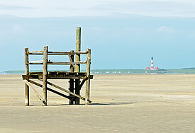 Strand bei St. Peter-Ording mit Leuchtturm Westerhever im Hintergrund.