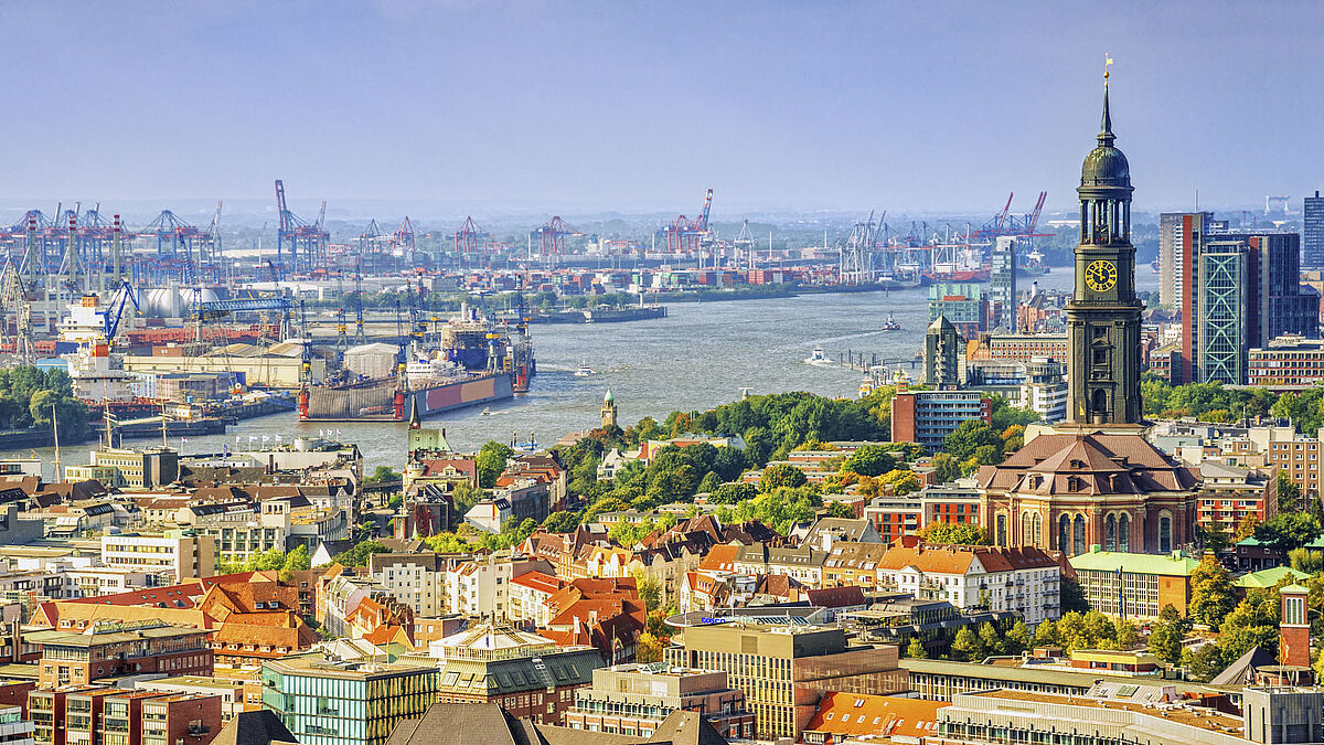Elevated view over HAmburg in autumn colors with the landmark St. Michel church, harbour and river Elbe