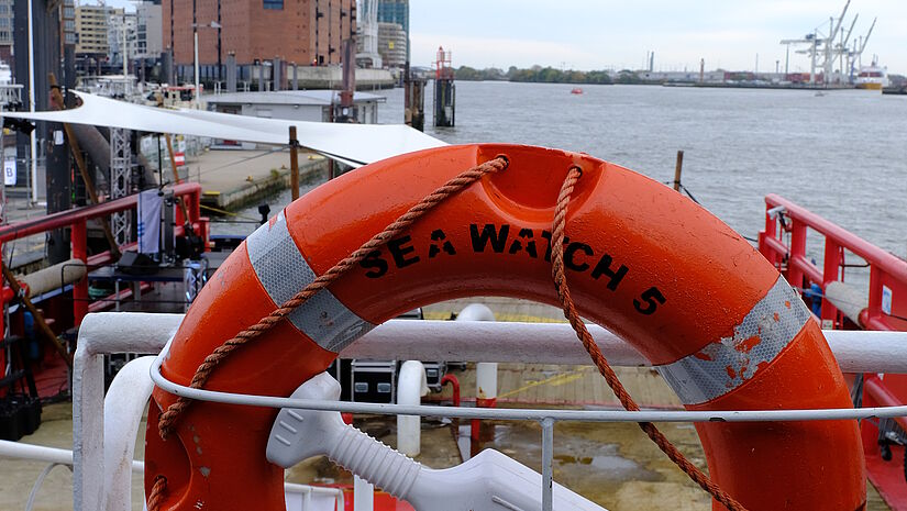 Rettungsring auf dem Achterdeck, im Hintergrund die Elbphilharmonie, während der Taufe der Sea-Watch 5, dem Rettungsschiff zur Seenotrettung, das an der Überseebrücke im Hamburger Hafen liegt.