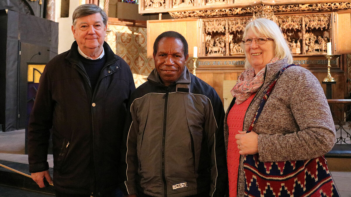 Johannes Pfeifer, Bischof Jack Urame und Frauke Pfeifer vor dem Brüggemann-Altar im Schleswiger St.-Petri-Dom