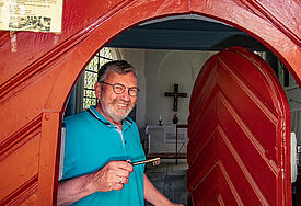 Küster Andreas Roxin vor der Wegekapelle zu Klein Grönau