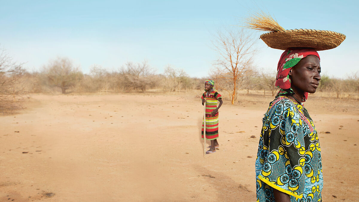 Eine Frau sucht nach Nahrung in der trockenen Landschaft rund um ihr Dorf  Luga (Niger).