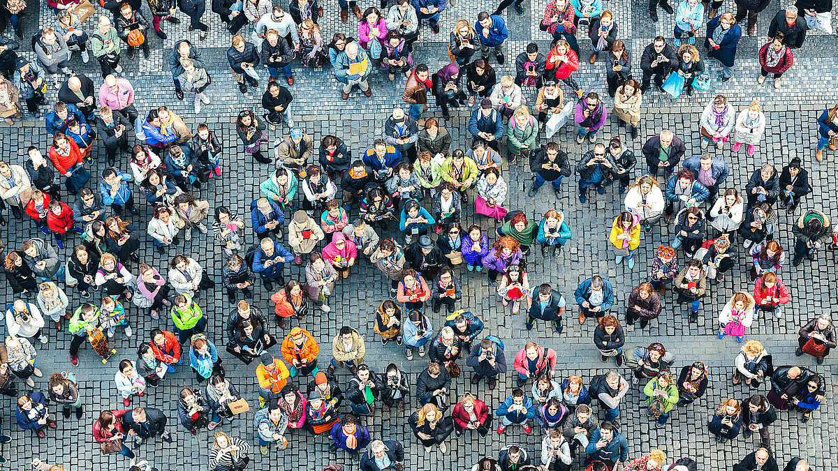 Viele Menschen in bunter Kleidung, von oben fotografiert