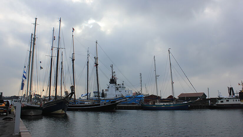 Abendliche Stimmung in einem kleinen Hafen. mehrere Traditionssegler habe angelegt.