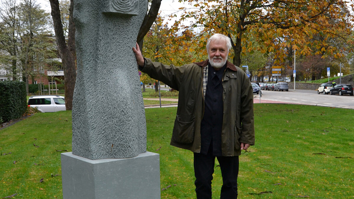 Der Künstler Ulrich Lindow neben seiner Skulptur 'Engel-Paradieswächter'