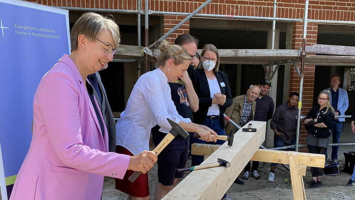 Landesbischöfin Kristina Kühnbaum-Schmidt und Rektorin Anne Gidion beim Einschlagen der Nägel