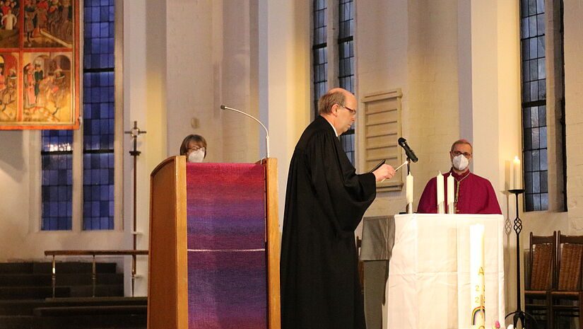 Gottesdienst in Kiel: Bischof Gothart Magaard entzündet eine Kerze zum Gedenken