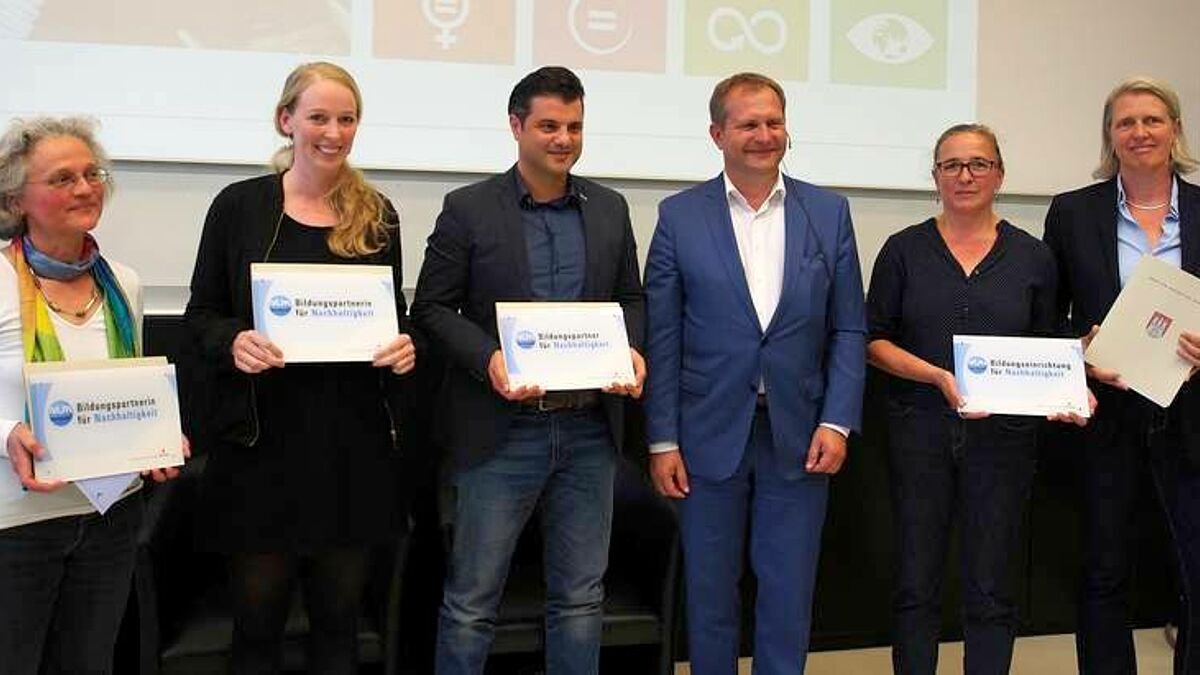 Senator Kerstan (dritter von rechts) überreichte Silvia Schubert (v.l.), Isabel Jensen, Hamed Abbaspur,  Claudia Hug und Dr. Mirjam Freytag das NUN-Zertifikat.