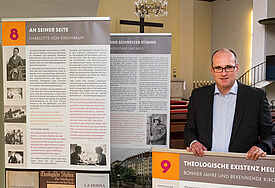 Pastor Dr. Stefan Holtmann zeigt die Ausstellungstafeln zum Theologen Karl Barth